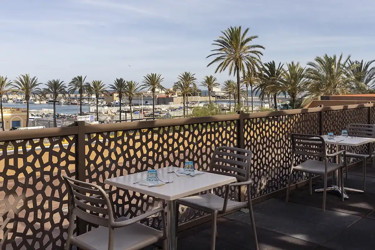 Terraza del restaurante con vistas al puerto en Las Palmeras affiliated by Fergus Hotels