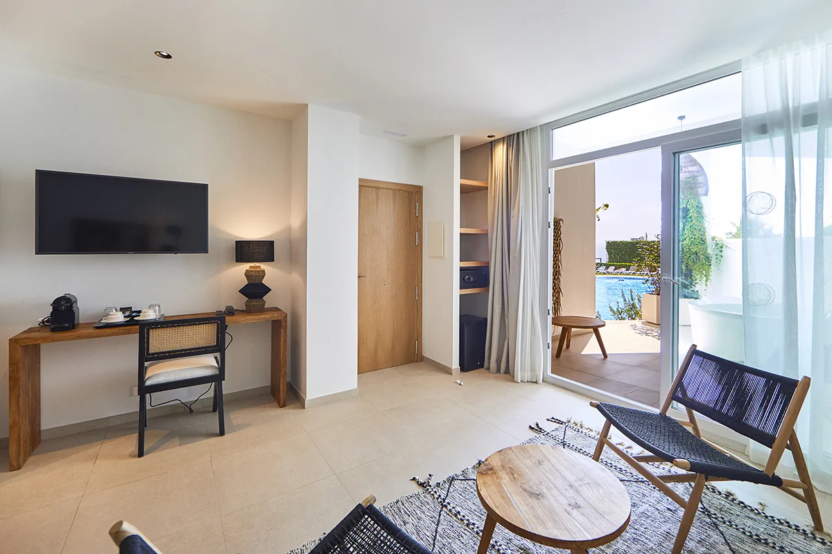 Salón con acceso a la terraza Zona de estar con escritorio y televisión la Suite Fergus Conil Park